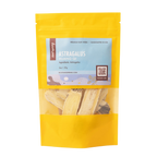 A yellow stand-up pouch of Root+Spring Huang Qi Astragalus raw herbs, featuring a light blue label with product details and a clear window showing the dried herb pieces inside.