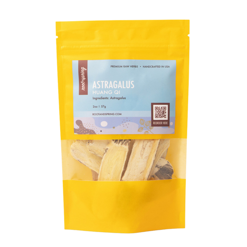A yellow stand-up pouch of Root+Spring Huang Qi Astragalus raw herbs, featuring a light blue label with product details and a clear window showing the dried herb pieces inside.