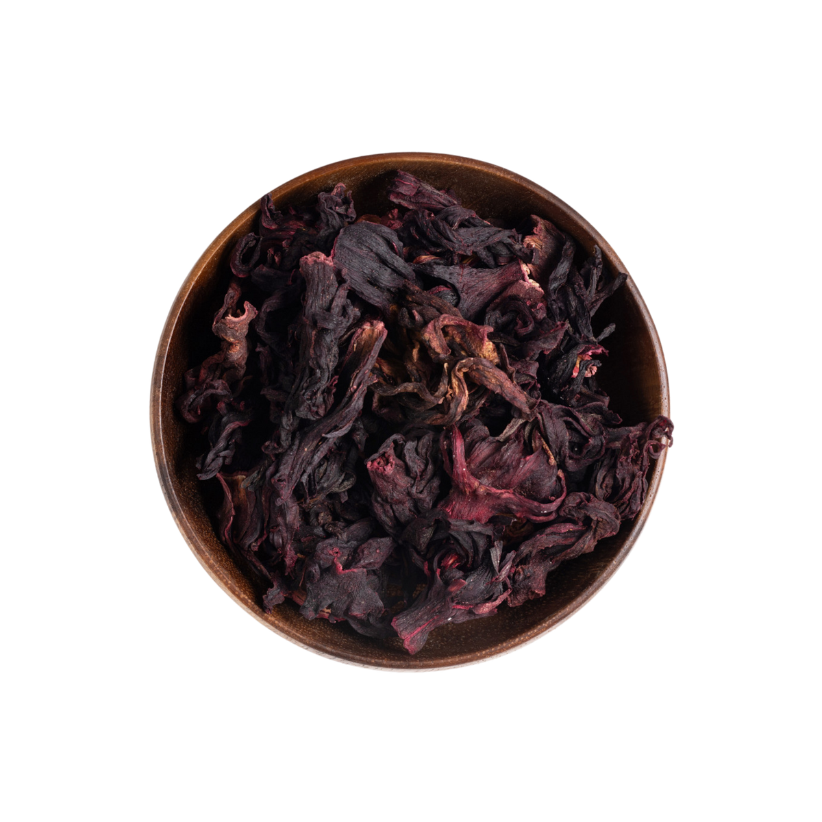 Dried dark red and purple hibiscus flowers piled in a round brown ceramic bowl, photographed from above on a plain white background.