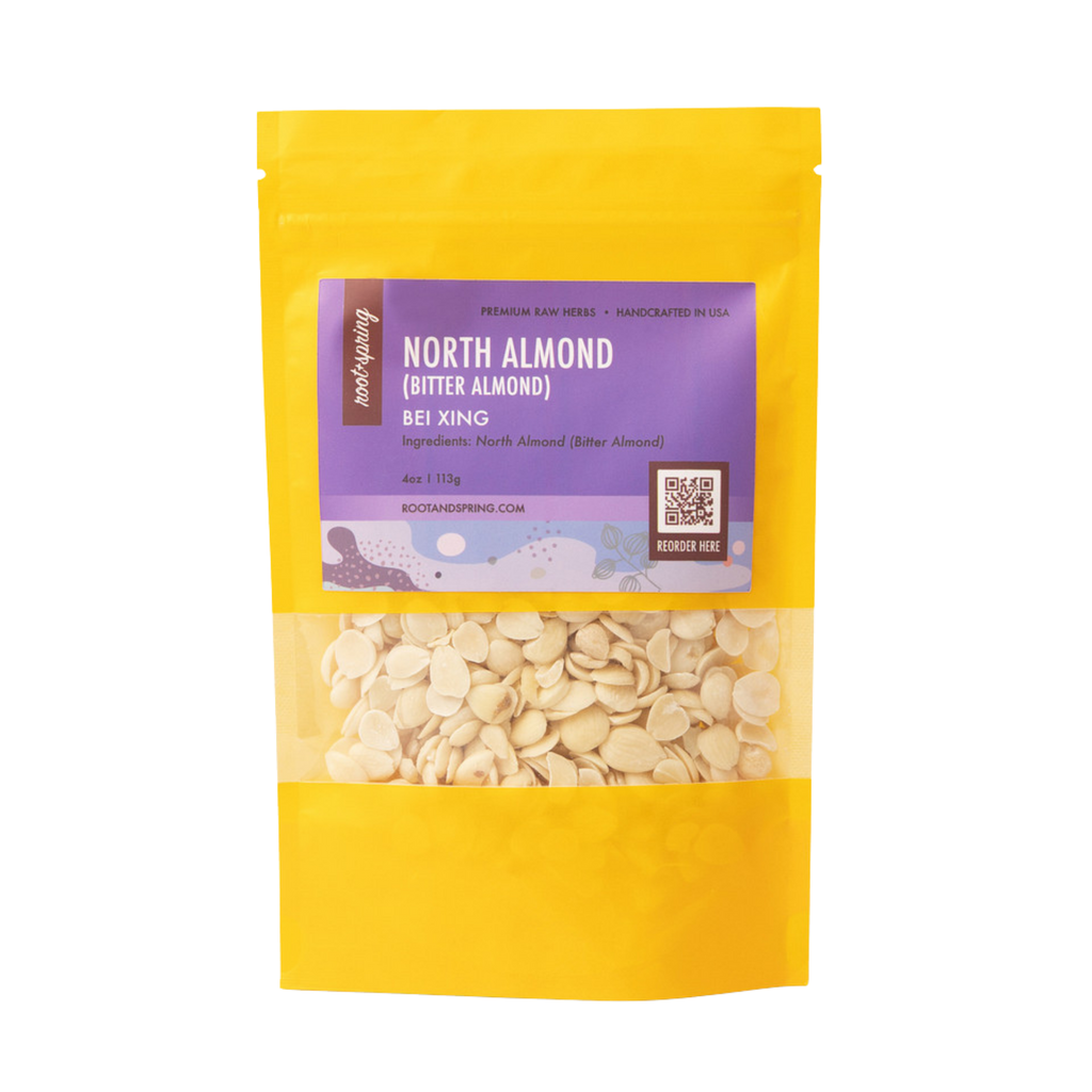 image of Root + Spring North Almond Raw Herbs featuring a purple label and a clear window showing the light beige flakes inside, set against a plain white background.