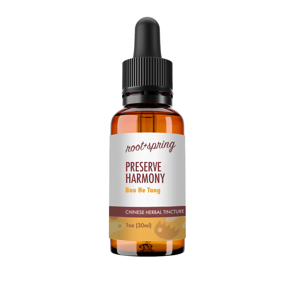 A 1 oz amber glass dropper bottle of Root+Spring Preserve Harmony Chinese Herbal Tincture, featuring a white label with brown and yellow text, and a black dropper cap, isolated on a white background.